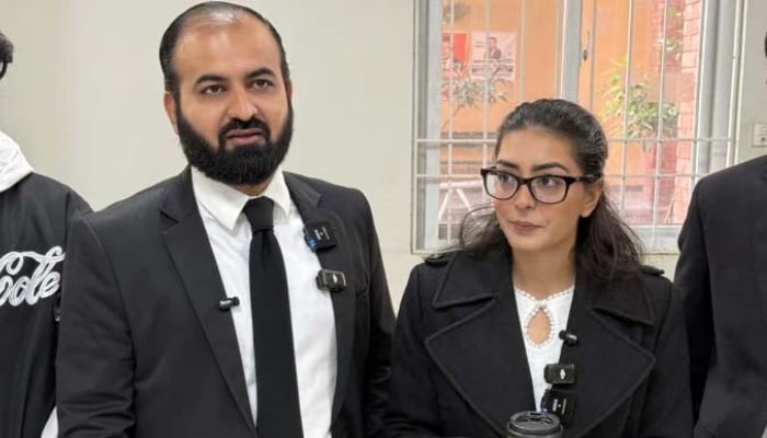 Human rights lawyer Imaan Mazari (right) with her husband and fellow lawyer Hadi Ali Chattha (left), during a court hearing in Islamabad on December 5, 2025. — AFP