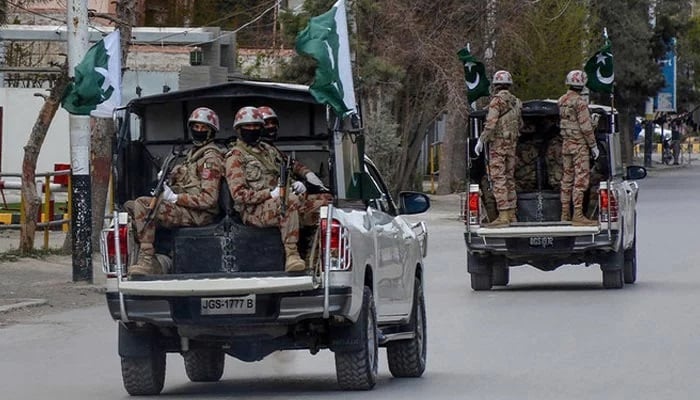Security personnel patrol in vehicles along a street in Quetta. — AFP/File