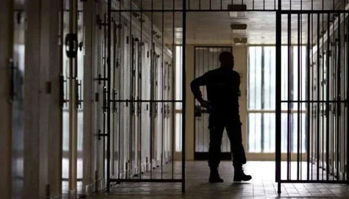 The representational image shows a security official standing guard in jail in this undated photo. — AFP/File