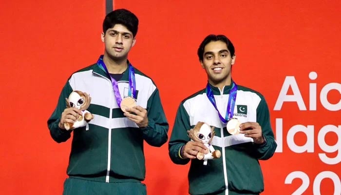 Pakistans Noor Zaman (left) and Mohammad Ashab Irfan pose with their Asian Games medals at the podium after their third-place playoff of the mens squash competition at the Nagoya Kinjo Futo Arena in Nagoya on September 27, 2026. — Reporter