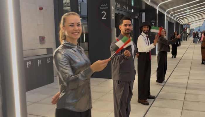 Etihad Rail staff welcome passengers with waving UAE flag during the launch ceremony of Etihad Rail, United Arab Emirates, September 30th, 2026. — Geo News