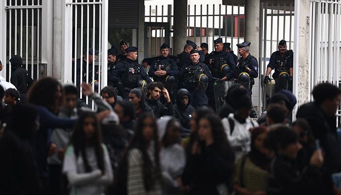 French CRS riot police stand guard in front of the entrance of the Lycee Paul Eluard high school as students continue a blockade to demand the hiring of substitute teachers, increased resources and better learning conditions, in Saint-Denis, near Paris, France, September 30, 2026. — Reuters
