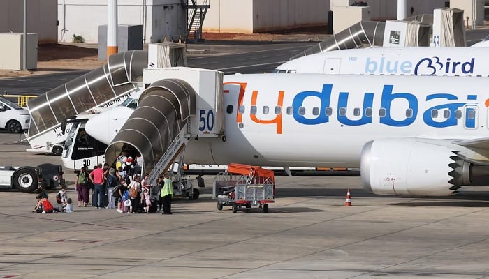 Travellers board a FlyDubai aircraft at Ben Gurion International Airport after a separate FlyDubai flight from the United Arab Emirates to Israel was diverted to Saudi Arabia following an emergency signal in Lod, near Tel Aviv, Israel, on September 30, 2026. — Reuters