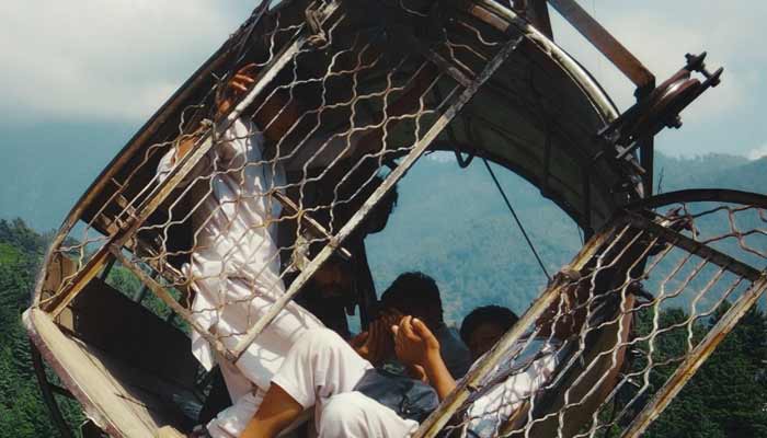 The picture shows a cable car carrying school children hanging by the wire in the ravine area. — Instagram/@mo_naqvi