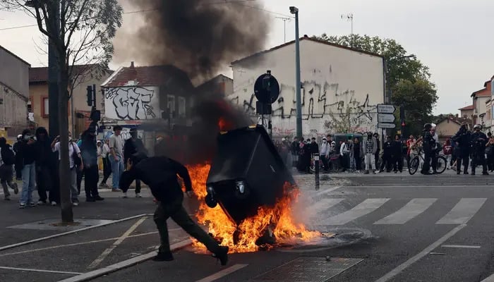 A protester throws a garbage bin into a fire outside the Lycee Deodat-de-Severac high school as part of nationwide protests by high school students to demand the hiring of substitute teachers, increased resources and better learning conditions, in Toulouse, France, October 2, 2026. — Reuters