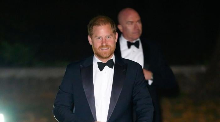 Prince Harry steps out in tuxedo for gala with special auction item from past