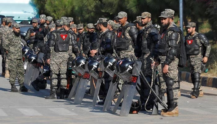 Pakistani Rangers in riot gear stand guard alongside a road to prevent a rally by Pakistan Tehreek-e-Insaf (PTI) supporters in Islamabad, November 25, 2024. — Reuters