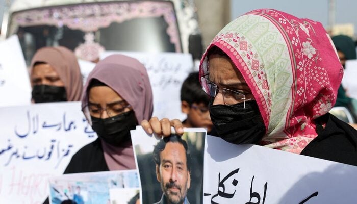 Families of the Pakistani hostage crew members of HONOUR 25 that was hijacked by pirates off the coast of Somalia, hold placards during a protest, calling the government to take immediate action for the safe return of their loved ones, in Karachi, May 13, 2026. — Reuters