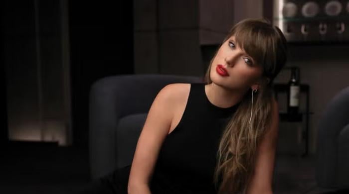 Taylor Swift celebrates UK chart double in symbolic burberry outfit