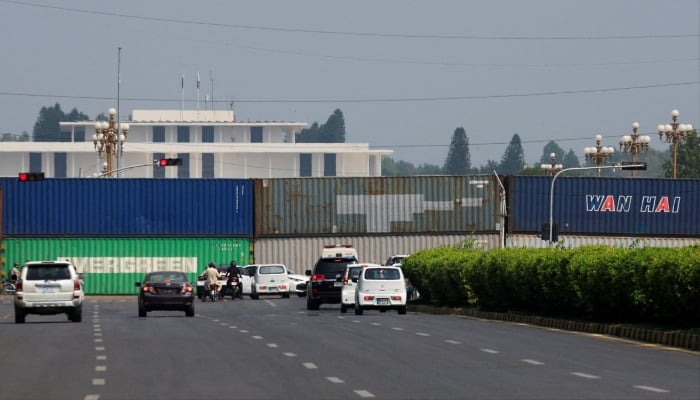 Shipping containers are used to block the road leading to the Aiwan-e-Sadr ahead of a planned march by PTI in Islamabad, September 24, 2026. — Reuters