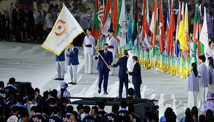 Olympic Council of Asia (OCA) President Sheikh Joaan bin Hamad Al-Thani (C) hands over the OCA flag to Qatars Prime Minister and Foreign Minister Sheikh Mohammed bin Abdulrahman bin Jassim Al-Thani during the closing ceremony of the 2026 Asian Games at Nagoya City Mizuho Park Athletic Stadium in Nagoya, Aichi Prefecture on October 4, 2026. — AFP