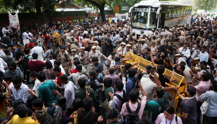 Demonstrators scuffle with police during a protest against the alleged assault of female protesters and journalists by Delhi Police, and demanding the resignation of Chief Election Commissioner Gyanesh Kumar, in New Delhi, India, on October 4, 2026. — Reuters