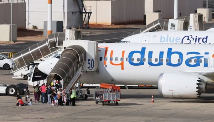 Travelers board a FlyDubai aircraft at Ben Gurion International Airport after a separate flyDubai flight from the United Arab Emirates to Israel was diverted to Saudi Arabia following an emergency signal, in Lod, near Tel Aviv, Israel, September 30, 2026. — Reuters