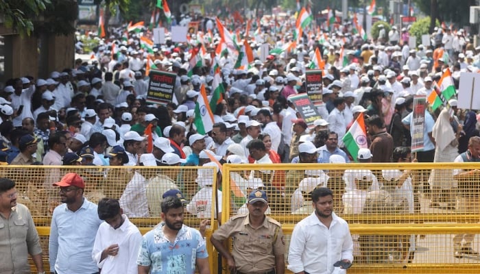 Supporters gather behind a barricade during a protest demanding the resignation of Indias Chief Election Commissioner Gyanesh Kumar organised by the Shiv Sena (UBT) and the Maharashtra Navnirman Sena (MNS) in Mumbai, India, October 4, 2026. — Reuters