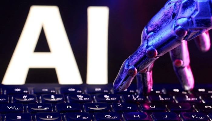 Letters spelling AI, a keyboard and a robotics hand in this illustration taken, September 23, 2026. — Reuters/File