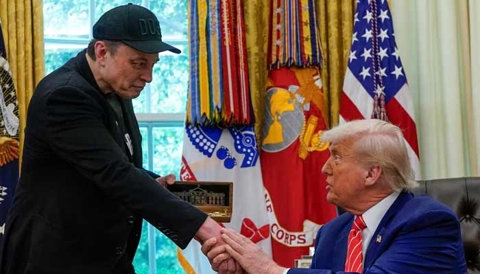 Elon Musk receives a golden key from US President Donald Trump in the Oval Office at the White House in Washington, DC, US, May 30, 2025. — Reuters