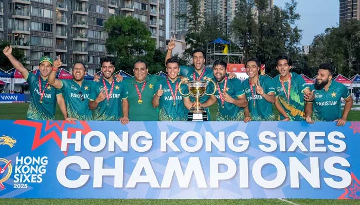 Pakistan players celebrate with the trophy after winning the Hong Kong Sixes title by defeating Kuwait in the final at the Mission Road Ground in Mong Kok on November 9, 2026. — X/@TheRealPCB