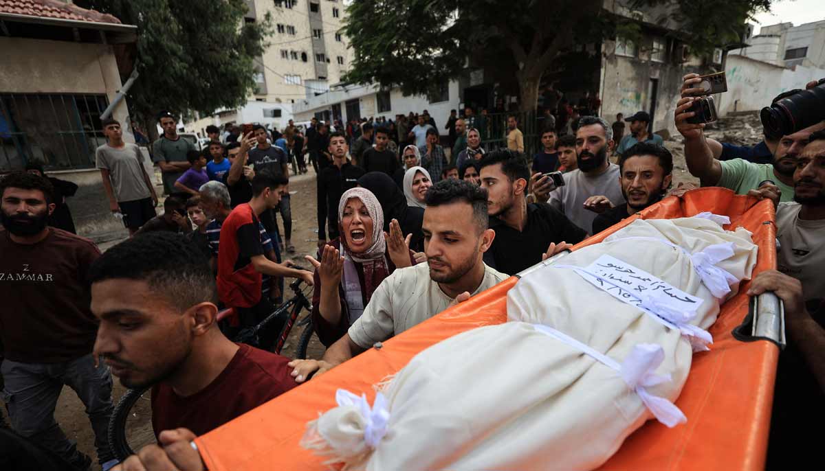 Mourners carry the body of Hussam Hawso, an 8-year-old Palestinian boy who was reportedly killed in an Israeli strike on residential buildings in the Sabra neighbourhood the previous night, during his funeral at Al-Shifa Hospital in Gaza City on October 9, 2026.— AFP