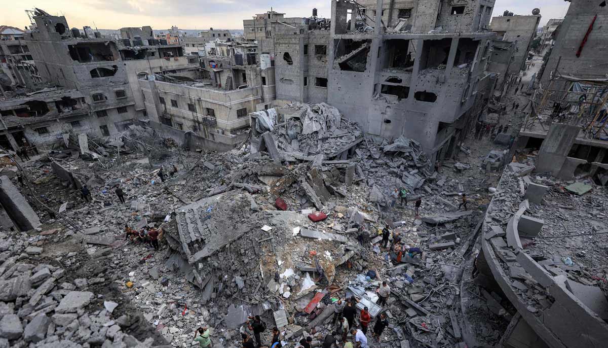People search the rubble of a collapsed building following overnight Israeli airstrikes in Gaza City on October 9, 2026. — AFP