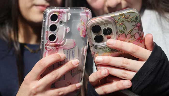 Image shows girls holding their mobile phones. — Reuters/ File