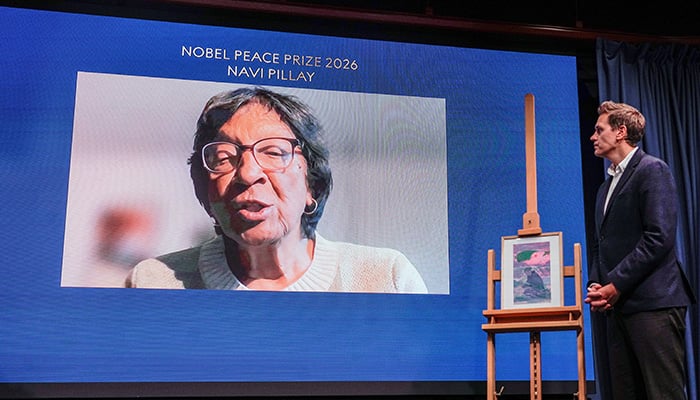 The Head of the Norwegian Nobel Committee, Jorgen Watne Frydnes (R) speaks with the 2026 Nobel Peace Prize laureate Navanethem Navi Pillay seen on a screen via video link at the Nobel Peace Center in Oslo on October 10, 2026. — AFP