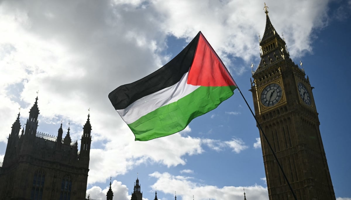 A Palestinian flag flutters in the breeze beside the Palace of Westminster as a National March in support of Palestine, organised by Palestine Solidarity Campaign, passes by, in central London on October 10, 2026. — AFP