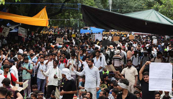 Supporters of Indias Cockroach Janata Party (CJP) hold signs during the ongoing protests, a few days after thousands of protesters marched towards parliament demanding the resignation of Education Minister Dharmendra Pradhan over National Eligibility cum Entrance Test (NEET) examination paper leaks, at Jantar Mantar in New Delhi, India, July 23, 2026. — Reuters