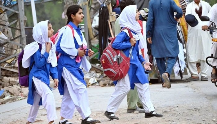 Students can be seen on their way to school in Lahore. — APP/File