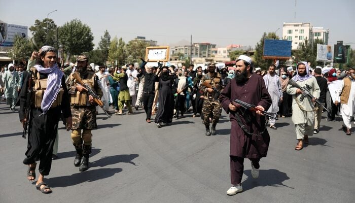 Taliban military personnel stand in front of protesters during the anti-Pakistan protest in Kabul, Afghanistan, September 7, 2021. — Reuters