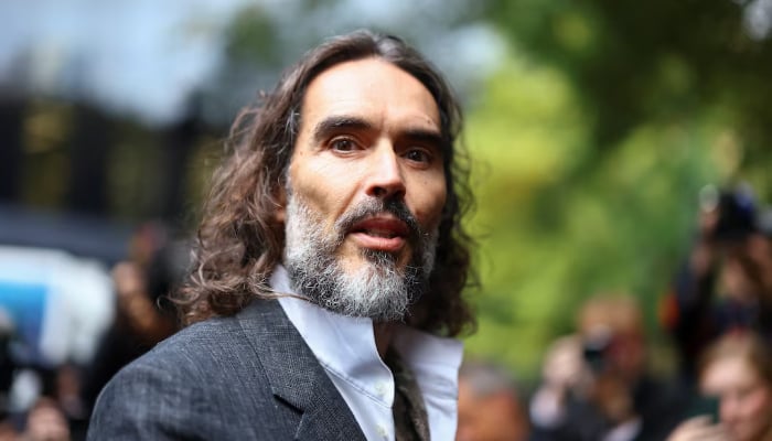 Russell Brand leans on one person during major assault case