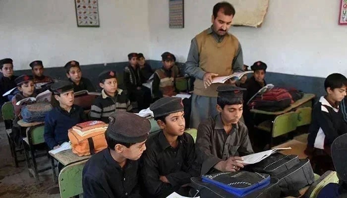 A teacher takes a class in a school in Peshawar. — AFP/File