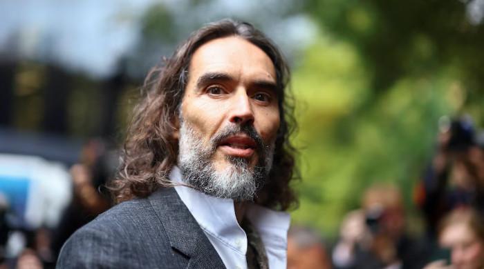 Russell Brand leans on one person during major assault case