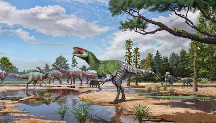 The meat-eating dinosaur Invictibellatrix amberina feeds on a mammal while grasping another in its ecosystem alongside other dinosaurs and other kinds of animals on the Isle of Wight, United Kingdom, in the Cretaceous Period around 120 million years ago, in this illustration released on October 13, 2026. — Reuters
