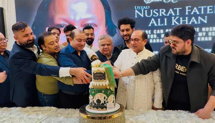 Rahat Fateh Ali Khan and his son Shahzaman Fateh Ali Khan cut cake during the legendary Nusrat Fateh Ali Khan 78th birthday celebration. — Minhaz Bashir