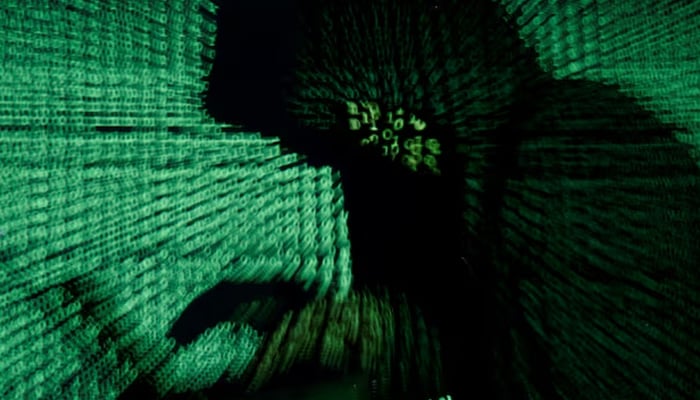 A man holds a laptop computer as cyber code is projected on him in this illustration picture taken on May 13, 2017. — Reuters