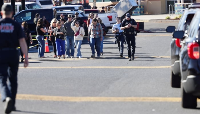 People walk at a family reunification location at Journey Church following a shooting at Silver Rail Elementary School in Bend, Oregon, US, October 15, 2026. — Reuters