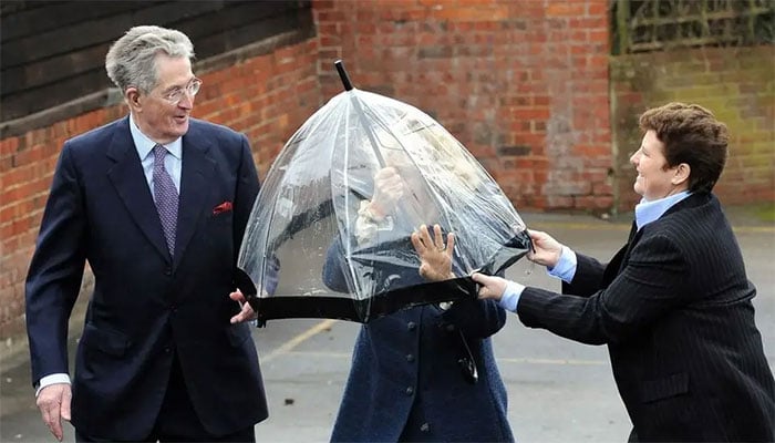Queen Camilla gets caught in royal pickle after umbrella turns against her