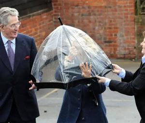 Queen Camilla gets caught in royal pickle after umbrella turns against her