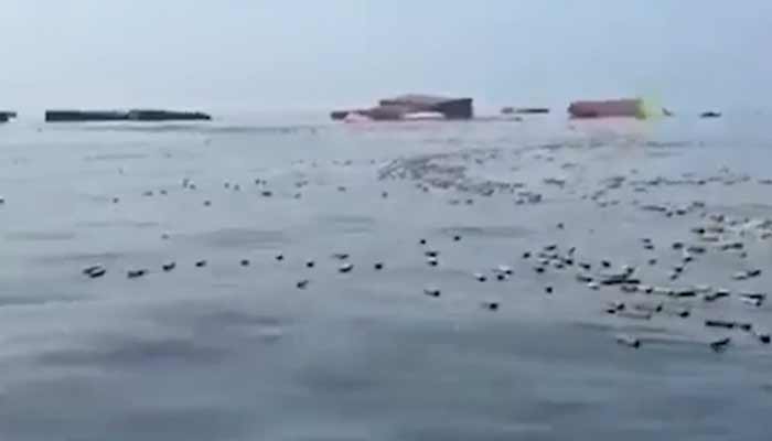 Screengrab shows iPhones floating in the water after a vessel reportedly met with an incident in the Strait of Hormuz. — X/@Telegraph