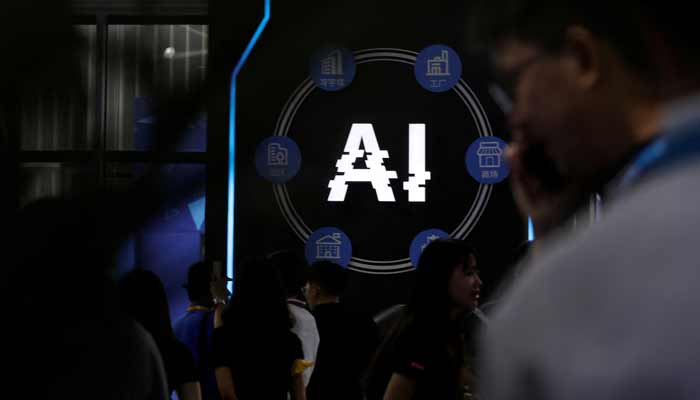 Visitors stand near a sign of artificial intelligence at an AI robot booth at Security China, an exhibition on public safety and security, in Beijing, China June 7, 2023. — AFP