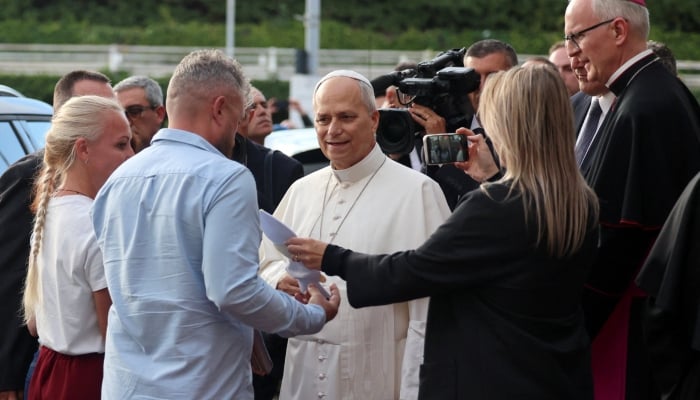 Pope Leo speaks to a Ukrainian family whose daughter is undergoing cancer treatment, as he leaves Gemelli hospital following lung surgery and cancer diagnosis, in Rome, Italy, October 17, 2026. — Reuters