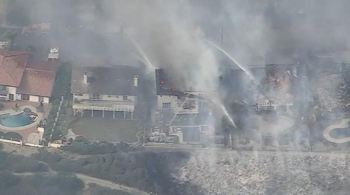 Santa Ana winds spark brush fires, triggering evacuations across Southern California