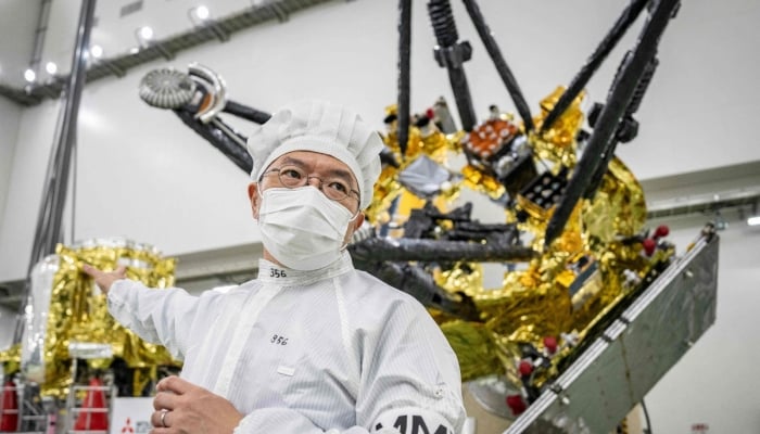 Yasuhiro Kawakatsu, project manager of the Mars Moons eXploration (MMX) mission, speaks to media in front of the MMX spacecraft at the Tanegashima Space Center in Minamitane, Kagoshima prefecture on August 13, 2026. — AFP