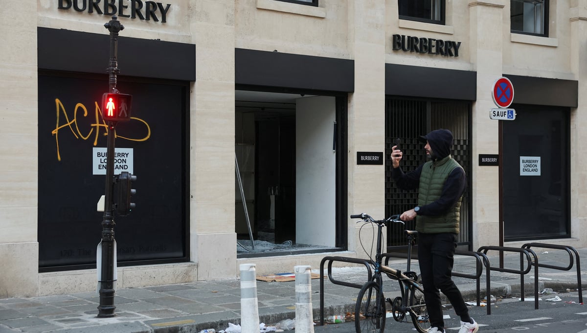 A man takes photos of a vandalised Burberry store, the day after clashes during a national day of demonstrations against the cost of living and rising fuel prices, in Paris, France, October 18, 2026. — Reuters