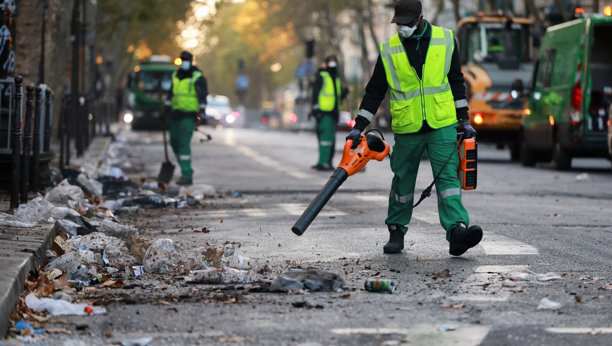 Workers clean a street a day after clashes during a national day of demonstrations against the cost of living and rising fuel prices, near (AREA) in Paris, France, October 18, 2026. — Reuters