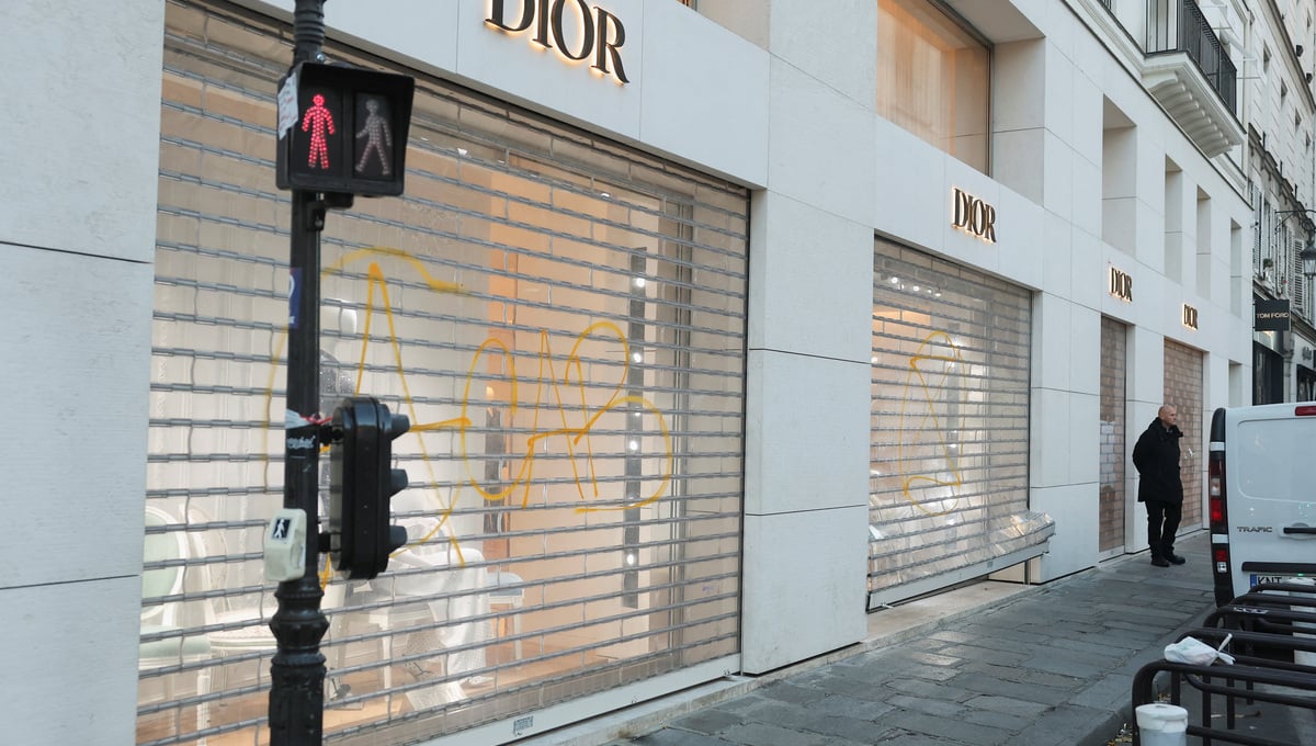 A man stands next to a vandalised Dior store, the day after clashes during a national day of demonstrations against the cost of living and rising fuel prices, in Paris, France, October 18, 2026. — Reuters