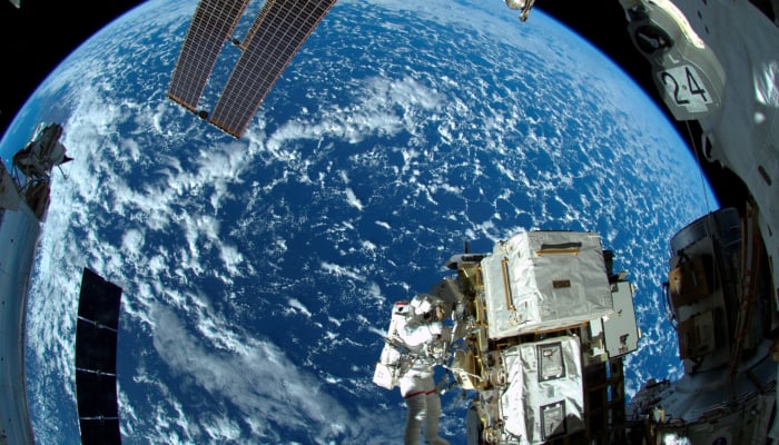 An astronaut works outside a space station airlock in this image released October 8, 2014. — Reuters