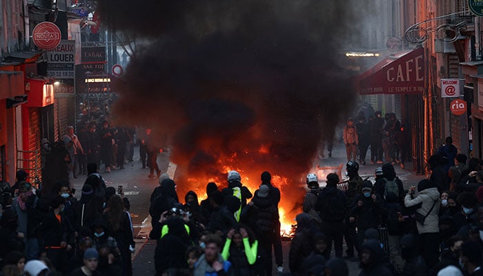 Flames and smoke rise, during civil unrest, the day after a national day of demonstrations against the cost of living and rising fuel prices, in Paris, France, October 18, 2026. — Reuters