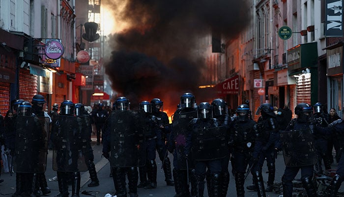 Flames and smoke rise during civil unrest, the day after a national day of demonstrations against the cost of living and rising fuel prices, in Paris, France, October 18, 2026. — Reuters