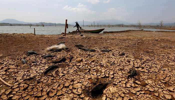 A fisherman walks to the waters edge in Jatigede Reservoir during the dry season in Sumedang, West Java, Indonesia. — Reuters